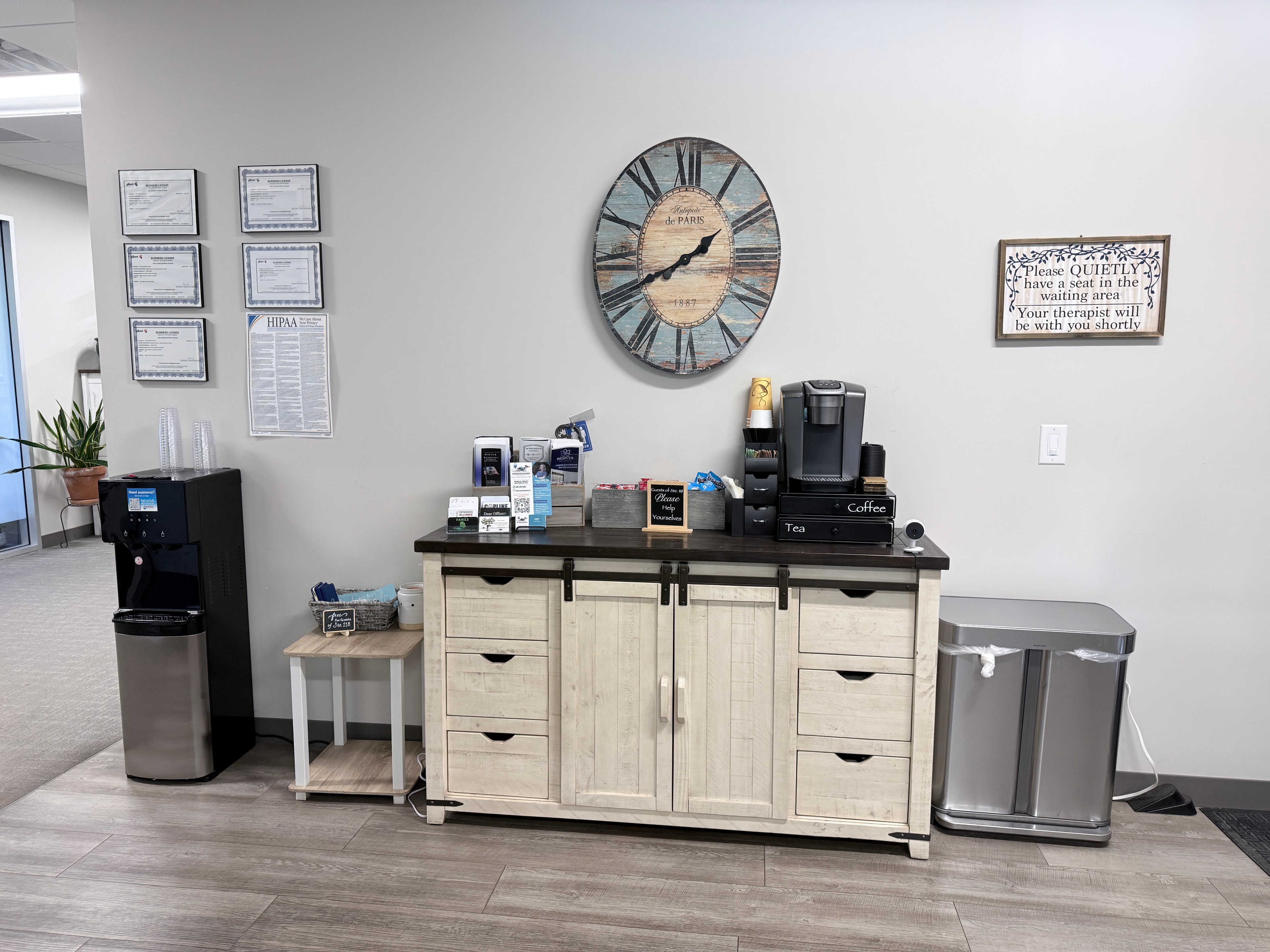 Refreshment station with coffee, tea, and water available for clients